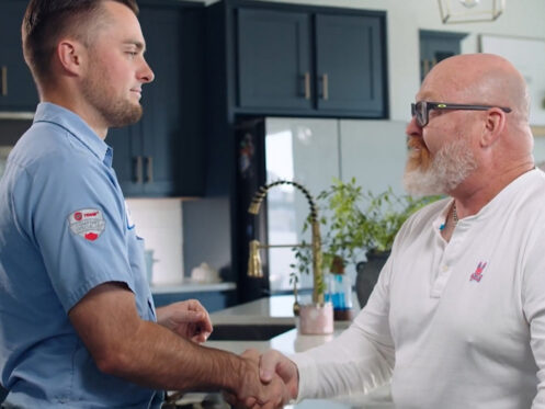 Arctic Air technician shaking hands with a homeowner